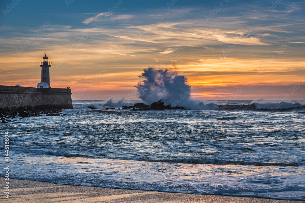 Poster Sunset view with lighthouse in Porto city, Portugal. View from Carneiro beach