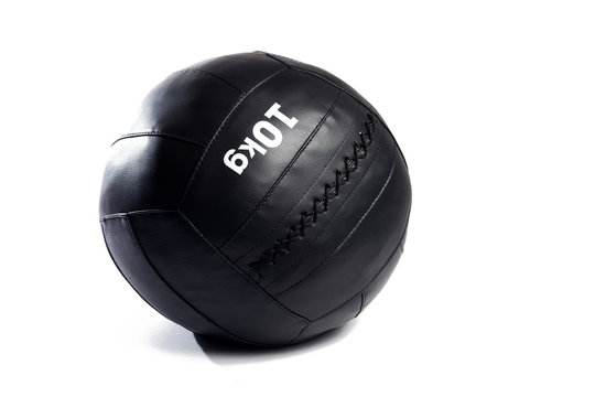 Medicine ball of black color. Genuine leather, lacing. White background, isolated