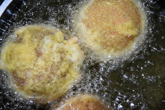 Champignons stuffed with cheese and sausage mixture, coated in flour, bread crumbs and fry in a pot.