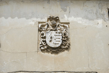 Stone coat of arms on the facade of an old building