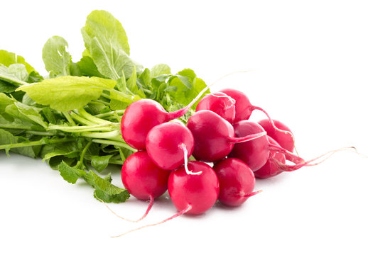 Fresh red radish vegetables with green leaves.