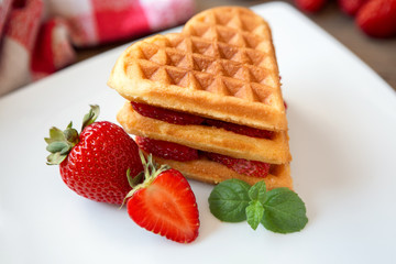 Belgian waffles with fresh strawberries  .