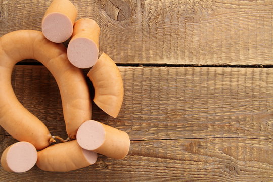 Fleischwurstring auf einem Holztisch geschnitten