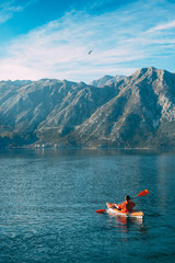Kayaks in the lake. Tourists kayaking on the Bay of Kotor, near the town of Perast in Montenegro. Aerial Photo drone.