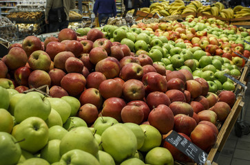 Red and green apples in a supermarket