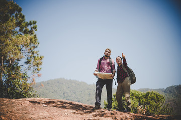 Man and woman Traveler with backpack on the mountain.