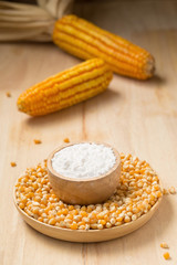 Corn flour in a bowl over a wooden table