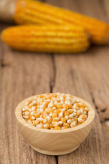 Corn flour in a bowl over a wooden table