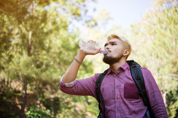 Men drinking water in the forest.