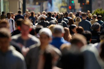 Crowd of people walking street in city