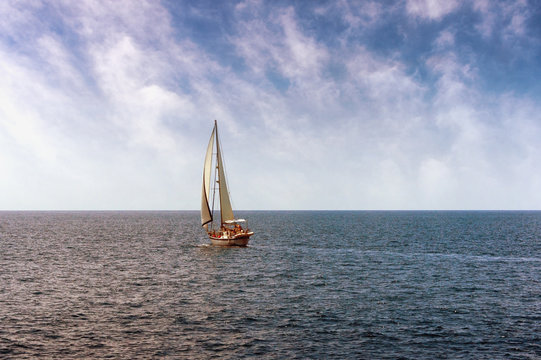 Fototapeta One sailing boat in open sea
