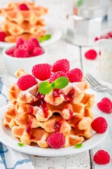 Homemade waffles with fresh raspberries for breakfast