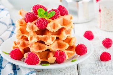 Homemade waffles with fresh raspberries for breakfast