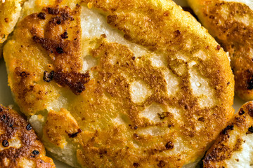 Golden pancakes in a frying pan. Cottage cheese fritters