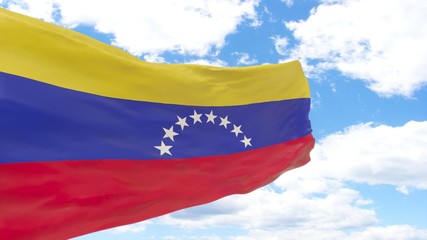 Waving flag of Venezuela on blue cloudy sky.