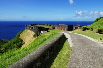 Brimstone Hill Fortress entrance gate and road in a bright sunny day with sea on the background