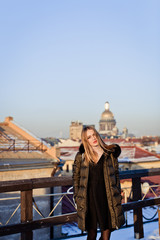 Picture of a girl against a background of snow and the city