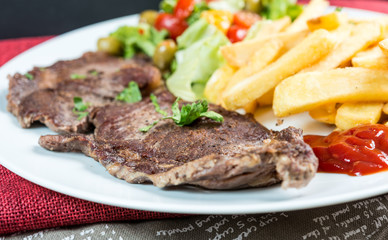 juicy steak beef meat with tomato and french fries