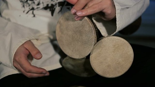 shot of man's hands drumming out a beat on an arabic percussion drum named Kasoureh