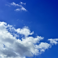 Panorama of spring, summer clouds on a blue sunny sky, background.