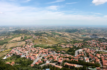 San Marino. Emilia-romagna. View on town with red roofs on blue sky background, horizontal view.