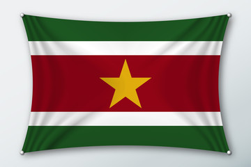 Obraz premium Suriname national flag. Symbol of the country on a stretched fabric with waves attached with pins. Realistic vector illustration.