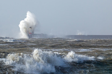 Fototapeta na wymiar Newhaven Lighthouse in Rough Sea
