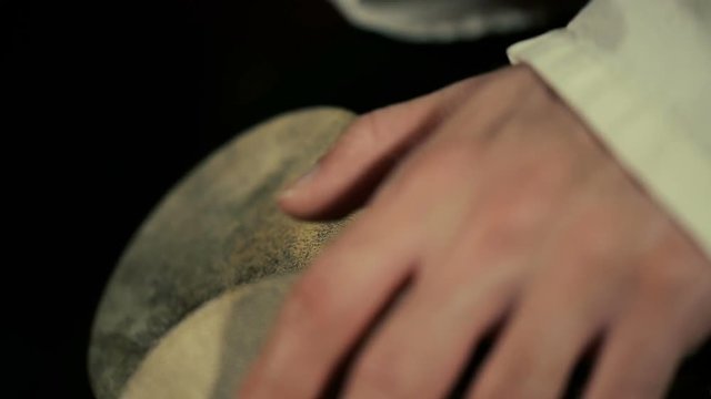 close up shot of man's hands drumming out a beat on an arabic percussion drum named Kasoureh