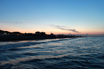 Obraz premium Italy. Emilia-Romagna. Rimini. Sea on blue pink sky background, horizontal view. Sunset.