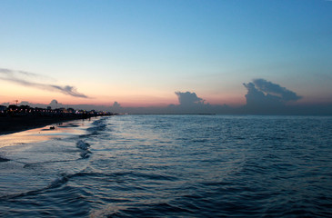 Fototapeta premium Italy. Emilia-Romagna. Rimini. Sunset on sea on blue pink sky background, horizontal view.