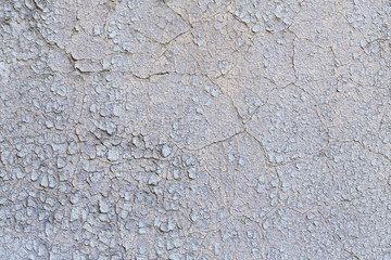 old grungy plastered wall with peeling color