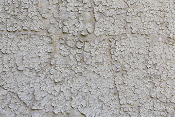 old grungy plastered wall with peeling color