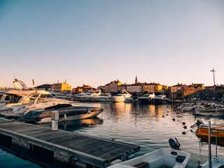 Fototapeta na wymiar Boats moored on the quay near the old town of Budva, in Montenegro, the Adriatic Sea