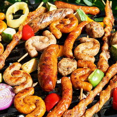 Assorted types of meat and vegetables on the grill
