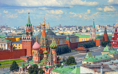 Obraz premium View on Moscow Red Square, Kremlin towers, stars and Clock Kuranti, Saint Basil's Cathedral church, Lenin mausoleum. Panorama from hotel Russia. Moscow holidays vacation tours famous sightseeing Putin
