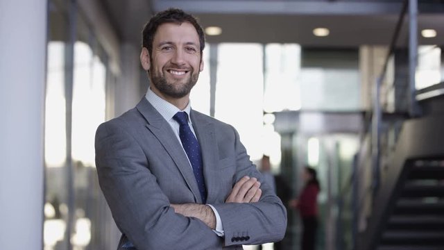  Portrait smiling successful businessman in large modern office building