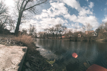 Fototapeta premium Spring landscape near the fisheye river.