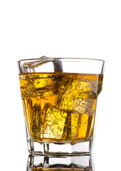 Glass of energy drink with bubbles and ice cubes