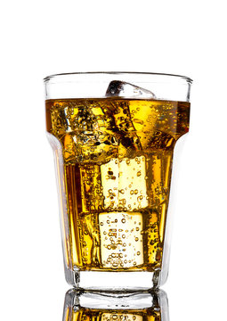 Glass of energy drink with bubbles and ice cubes