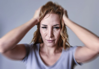 attractive woman on her thirties sad and depressed looking at the camera in sorrow and grief