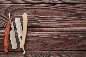 Vintage barber shop straight razor tool on wooden background