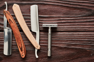 Vintage barber shop razor tools on wooden background