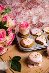 Cupcake with pink glaze on the wooden background. Selective focus.