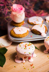 Cupcake with pink glaze on the wooden background. Selective focus.