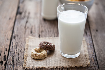 milk and cookies on wooden background