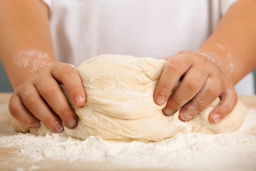 children's hands and the hands of his mother and knead dough together