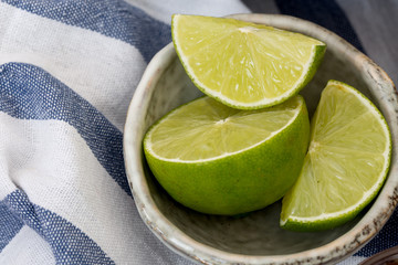 green lemon or lime group and slice in bowl