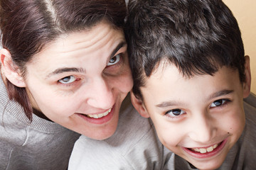 Mother and son looking at you other with joy.