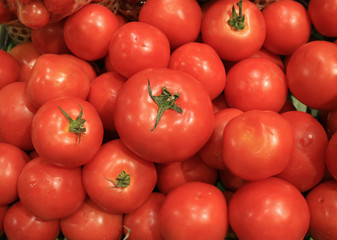 Heap of Vibrant Red Ripe Tomatoes with Green Stems