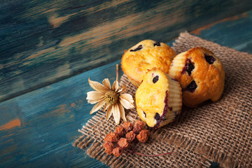 muffin with blueberries on a wooden table. sweet pastries on the board